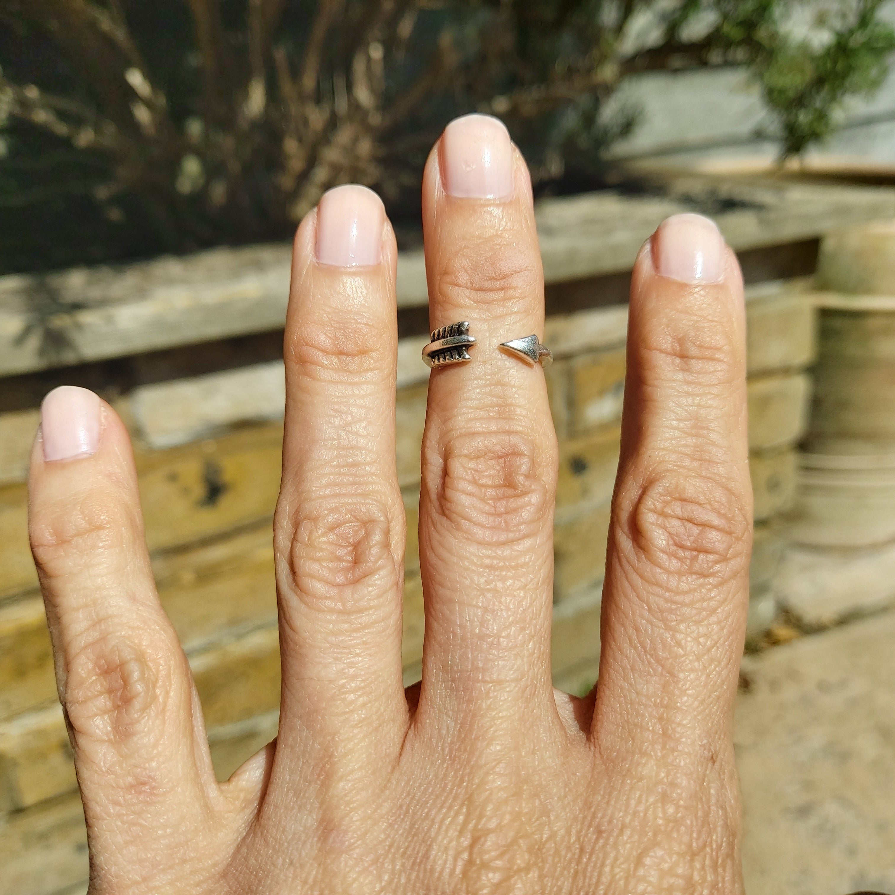 Boho silver arrow ring styled on hand, adjustable minimalist stacking midi
